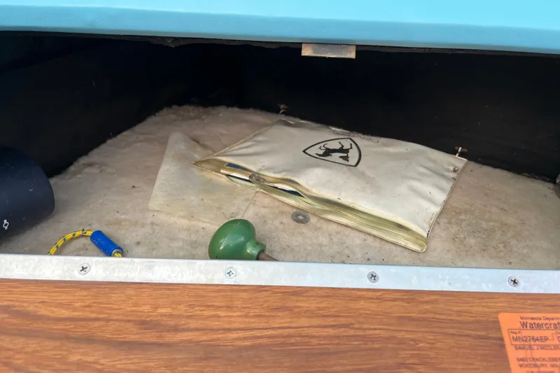 Slide: The Image of Storage compartment in 1983 Century 3000 Bowrider boat with manual and accessories. - 18