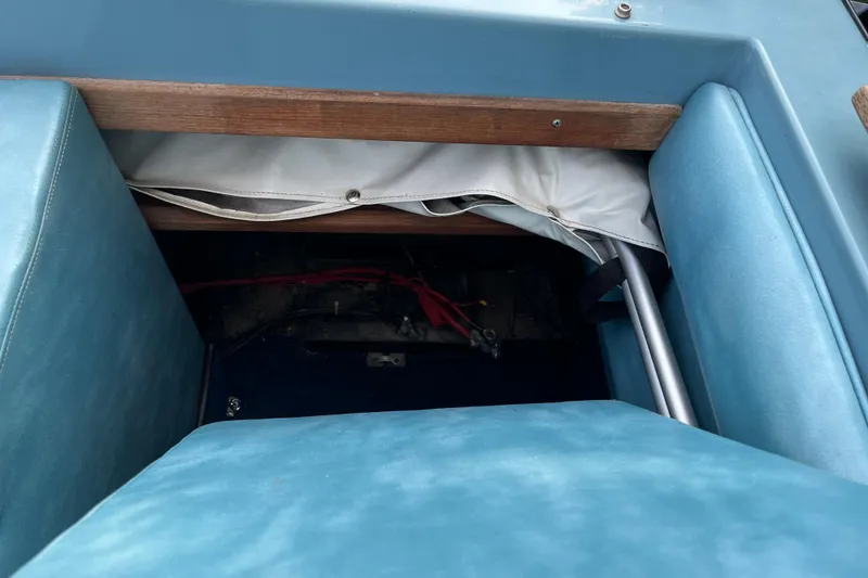 Slide: The Image of Interior view of a 1983 Century 3000 Bowrider boat with blue seating. - 24