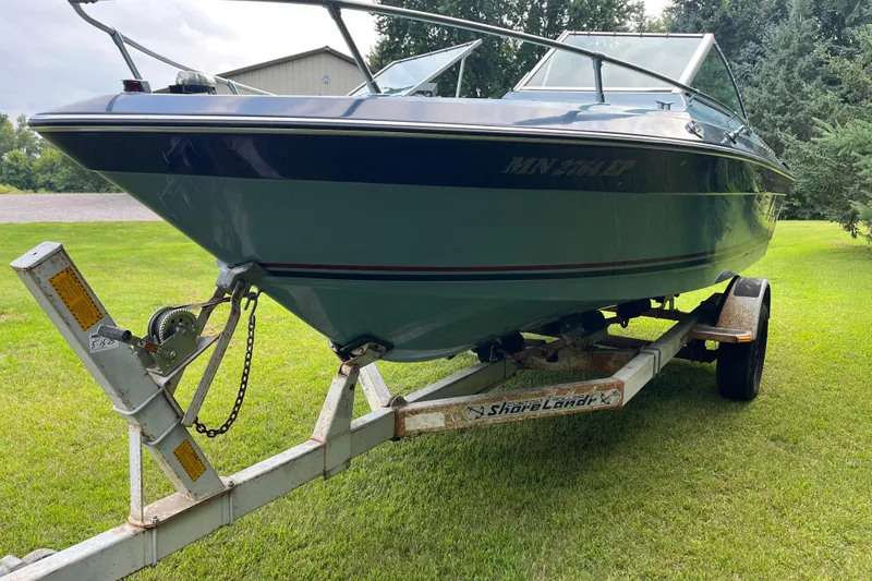 Slide: The Image of 1983 Century 3000 Bowrider boat on trailer, parked on grassy lawn. - 3