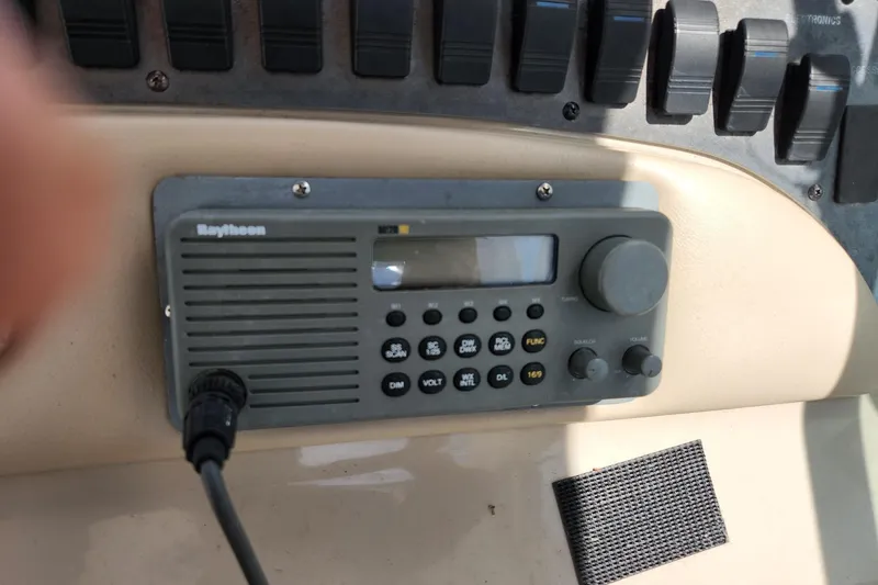 Slide: The Image of Raytheon marine radio on 1999 Sea Ray 310 Sundancer dashboard. - 12