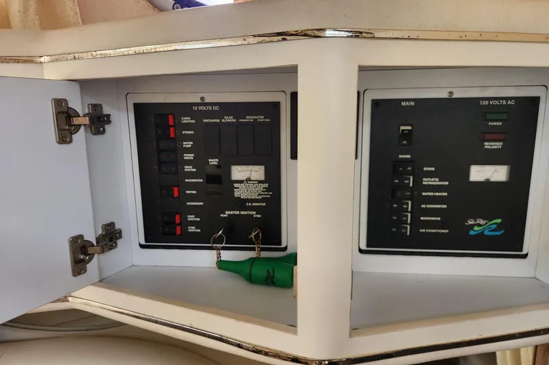 Slide: The Image of Electrical panel of a 1999 Sea Ray 310 Sundancer boat, showing 12V DC and 120V AC systems. - 18