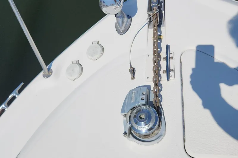 Slide: The Image of Bow deck of 1999 Sea Ray 310 Sundancer with anchor chain and winch. - 4