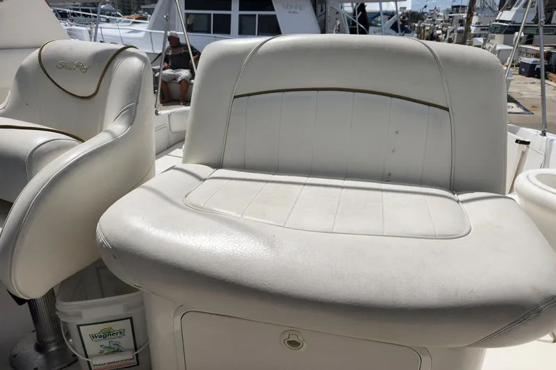Slide: The Image of 1999 Sea Ray 310 Sundancer boat with white leather seating on deck. - 5