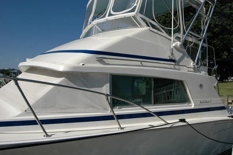 Slide: The Image of 1987 Bertram 33 Sport Fisherman boat with sleek design and blue accents. - 14
