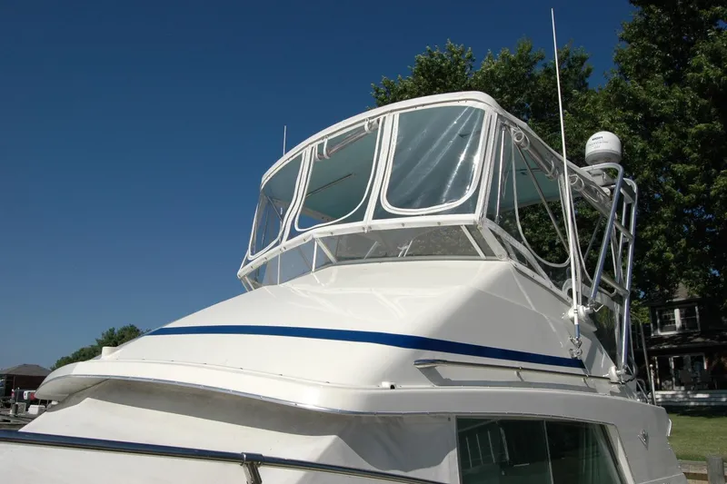 Slide: The Image of 1987 Bertram 33 Sport Fisherman boat with clear blue sky background. - 15
