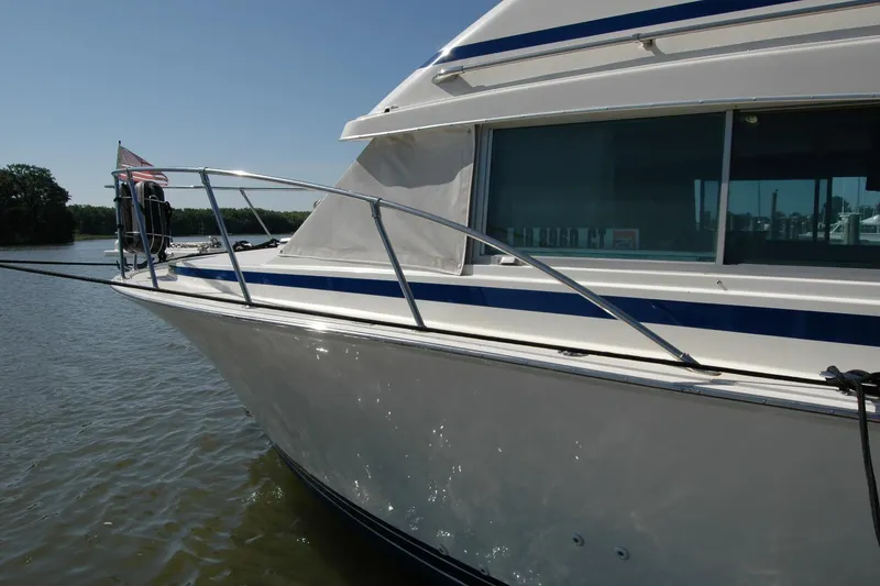 Slide: The Image of 1987 Bertram 33 Sport Fisherman boat docked on calm water. - 18