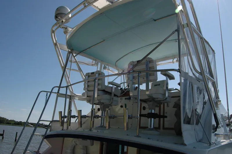 Slide: The Image of 1987 Bertram 33 Sport Fisherman boat with upper deck seating and canopy. - 20