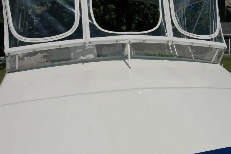Slide: The Image of 1987 Bertram 33 Sport Fisherman boat with clear windshield and white deck. - 25