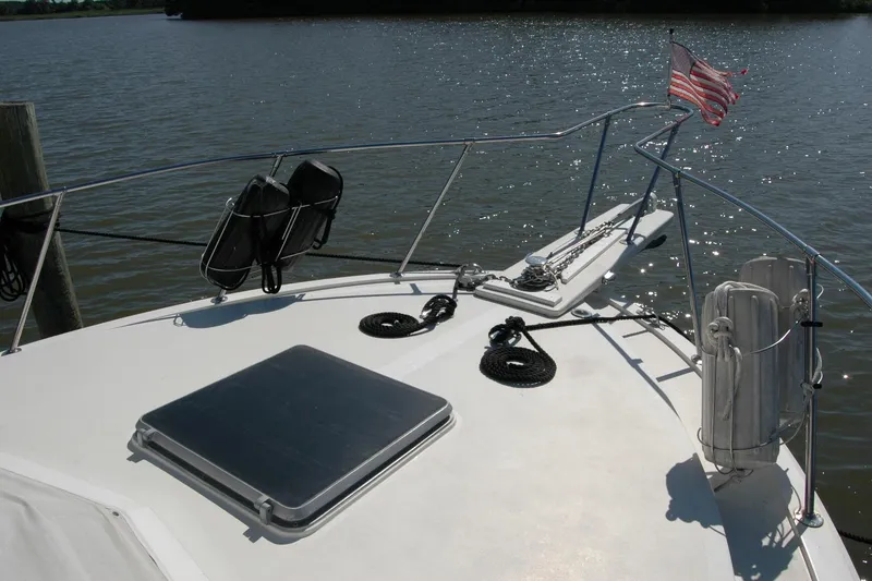 Slide: The Image of 1987 Bertram 33 Sport Fisherman boat deck with American flag and water view. - 26