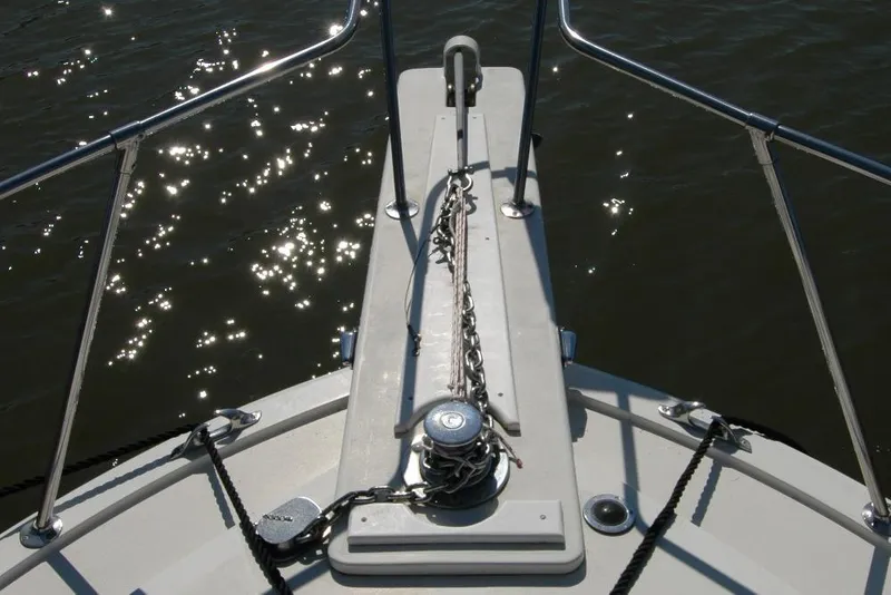 Slide: The Image of Bow of 1987 Bertram 33 Sport Fisherman with anchor chain, glistening water. - 27