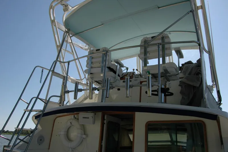 Slide: The Image of 1987 Bertram 33 Sport Fisherman boat with upper deck and seating area. - 28