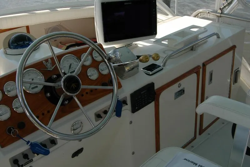 Slide: The Image of 1987 Bertram 33 Sport Fisherman helm with steering wheel and navigation instruments. - 31