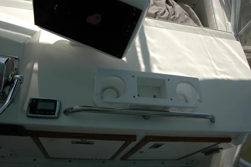 Slide: The Image of Control panel of a 1987 Bertram 33 Sport Fisherman boat with cup holders. - 39