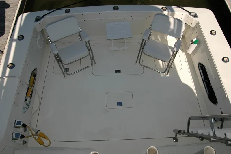 Slide: The Image of 1987 Bertram 33 Sport Fisherman deck with chairs and fishing equipment. - 43