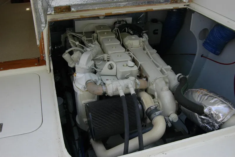 Slide: The Image of Engine compartment of a 1987 Bertram 33 Sport Fisherman boat, showcasing detailed machinery. - 45