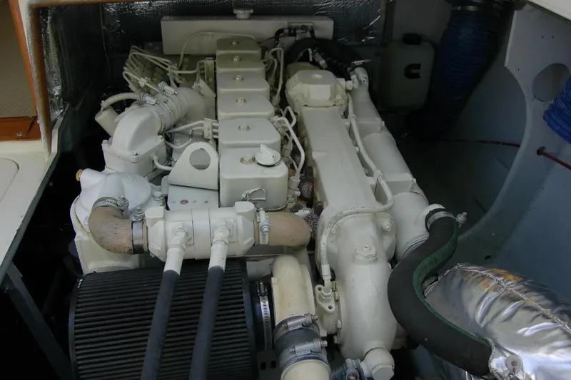 Slide: The Image of Engine compartment of a 1987 Bertram 33 Sport Fisherman boat, showcasing detailed machinery. - 47