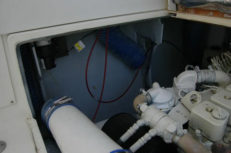 Slide: The Image of Engine compartment of a 1987 Bertram 33 Sport Fisherman boat, showing mechanical components. - 51