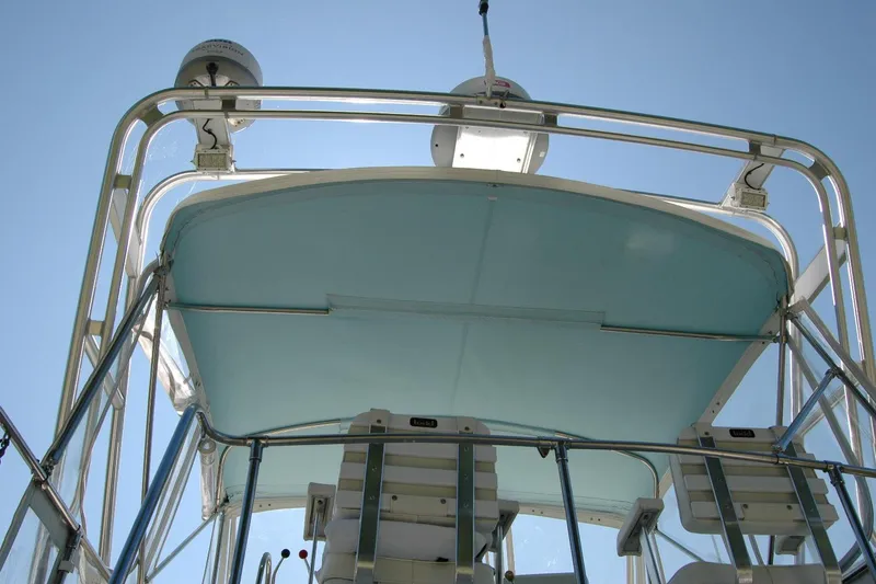 Slide: The Image of 1987 Bertram 33 Sport Fisherman boat, view of upper deck and equipment against clear sky. - 57
