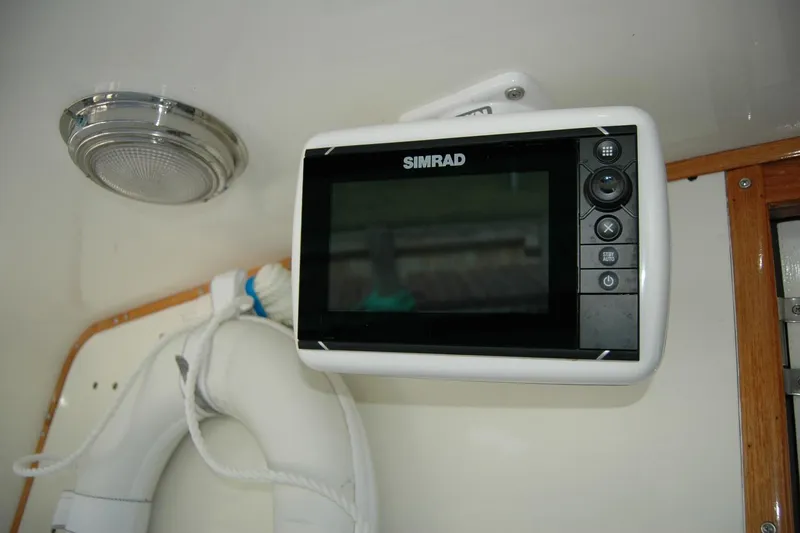 Slide: The Image of Simrad marine display on 1987 Bertram 33 Sport Fisherman boat interior. - 59