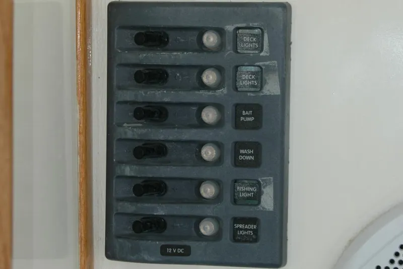 Slide: The Image of Control panel on a 1987 Bertram 33 Sport Fisherman boat with labeled switches. - 60