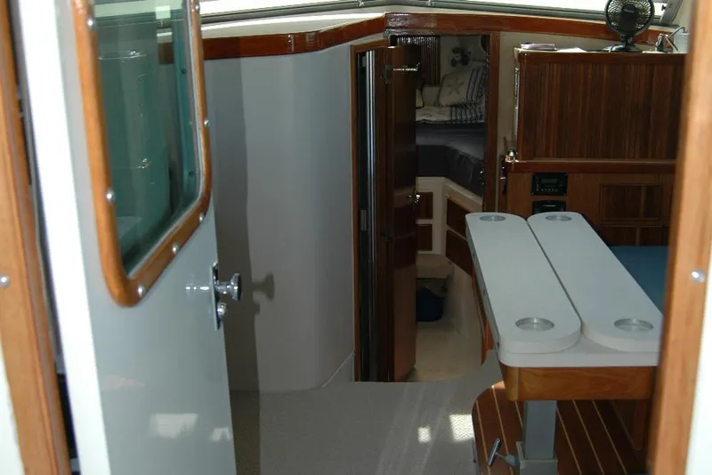 Slide: The Image of Interior view of 1987 Bertram 33 Sport Fisherman, featuring wood accents and cabin entry. - 61