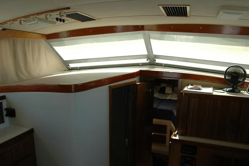 Slide: The Image of Interior of 1987 Bertram 33 Sport Fisherman with wood accents and cabin view. - 62