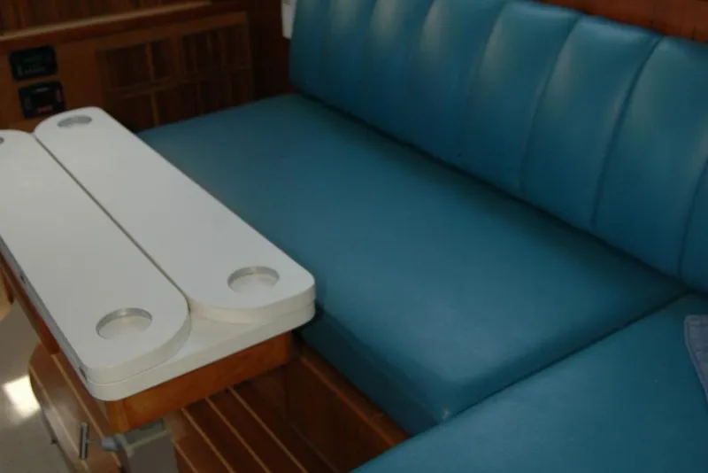 Slide: The Image of 1987 Bertram 33 Sport Fisherman interior with blue seating and white table. - 68