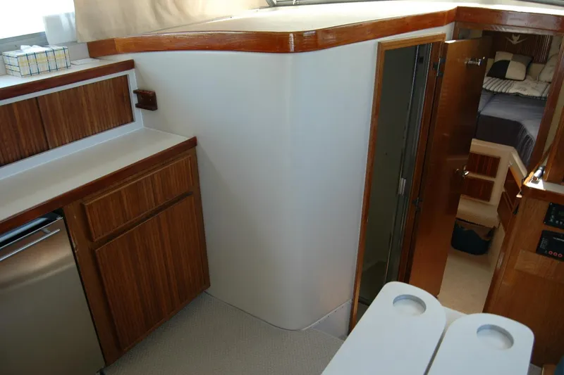 Slide: The Image of Interior of 1987 Bertram 33 Sport Fisherman with wood cabinetry and cozy sleeping area. - 72