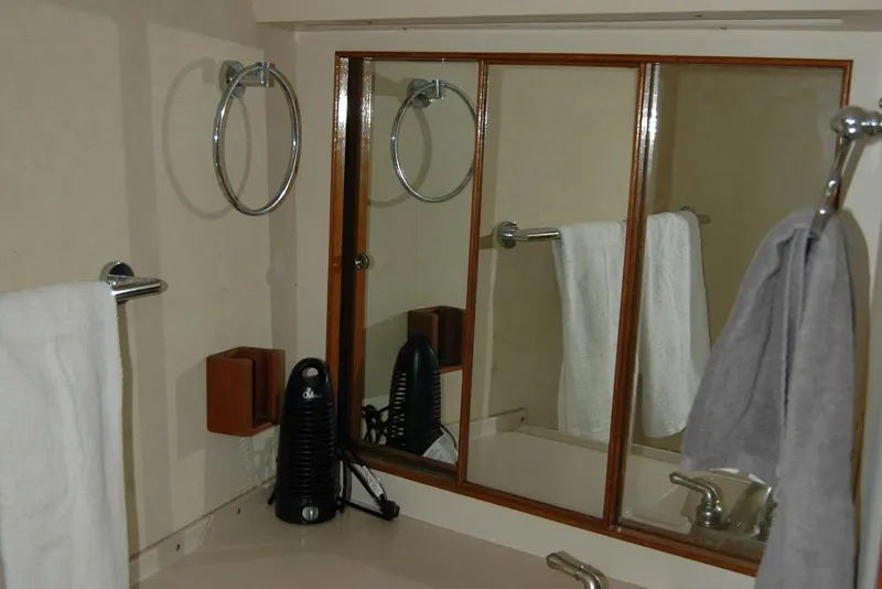 Slide: The Image of Bathroom interior of 1987 Bertram 33 Sport Fisherman with mirror and towels. - 78