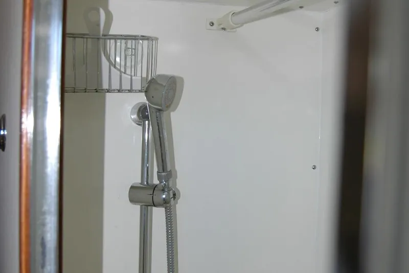 Slide: The Image of Shower area in 1987 Bertram 33 Sport Fisherman boat, featuring chrome fixtures. - 83