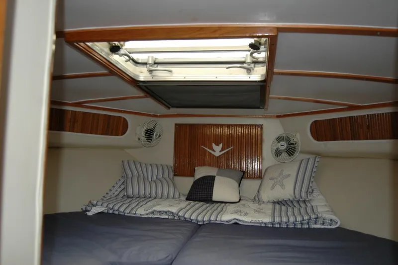 Slide: The Image of Interior cabin of 1987 Bertram 33 Sport Fisherman with cozy bedding and ceiling hatch. - 88