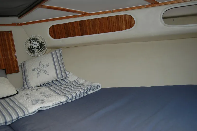 Slide: The Image of Cozy cabin interior of 1987 Bertram 33 Sport Fisherman with nautical-themed bedding. - 90