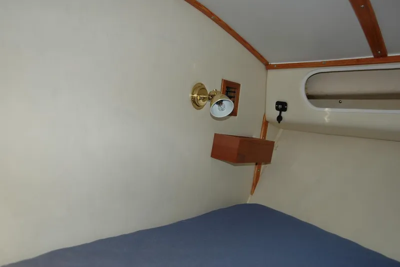 Slide: The Image of Interior cabin of 1987 Bertram 33 Sport Fisherman with wall lamp and shelf. - 91