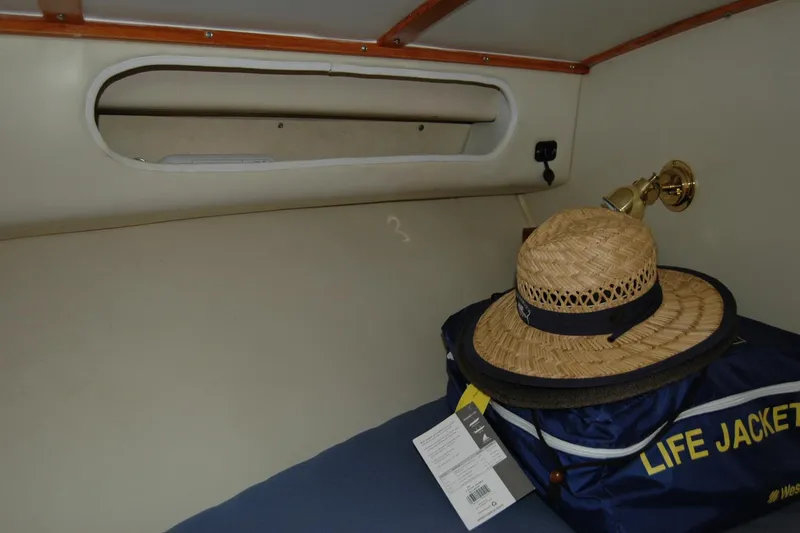 Slide: The Image of 1987 Bertram 33 Sport Fisherman cabin interior with straw hat and life jacket. - 92