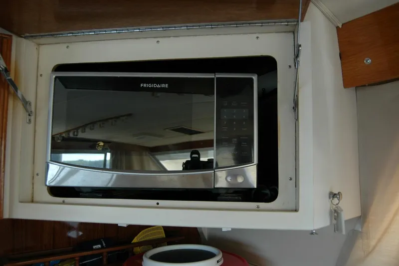 Slide: The Image of Frigidaire microwave installed in 1987 Bertram 33 Sport Fisherman boat interior. - 93
