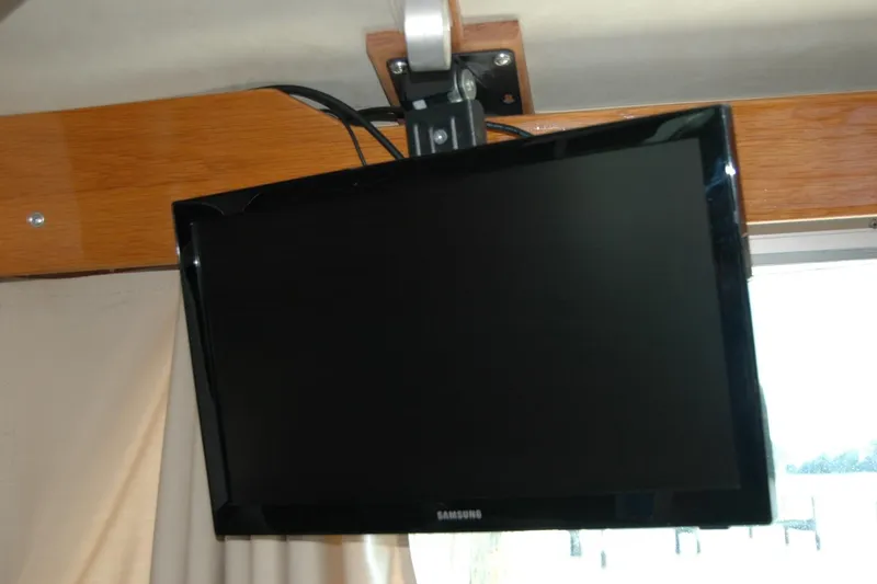 Slide: The Image of Wall-mounted Samsung TV inside 1987 Bertram 33 Sport Fisherman boat. - 94