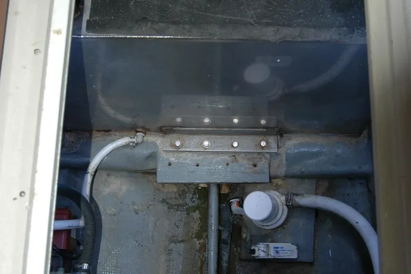 Slide: The Image of Bilge area of 1987 Bertram 33 Sport Fisherman with visible pipes and fittings. - 95