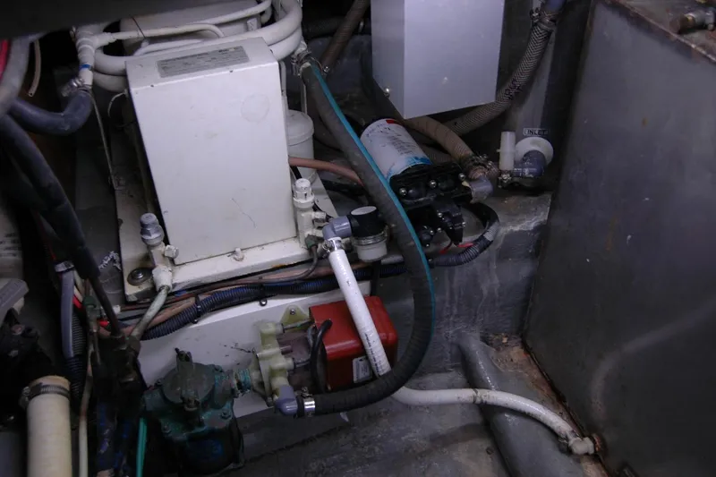 Slide: The Image of Engine room of 1987 Bertram 33 Sport Fisherman with various mechanical components and wiring. - 96