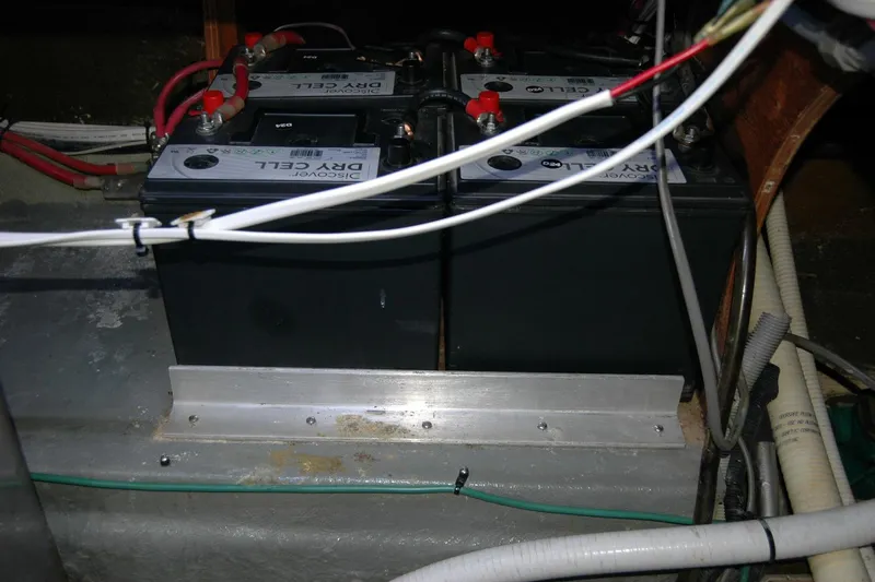 Slide: The Image of Battery compartment of a 1987 Bertram 33 Sport Fisherman boat, featuring dry cell batteries. - 97