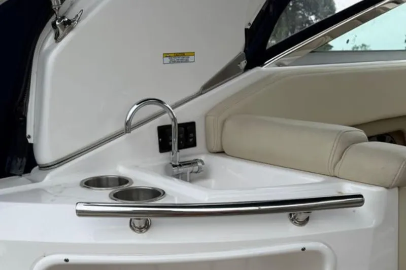 Slide: The Image of 2020 Regal 28 Express boat interior with sink and cup holders. - 11