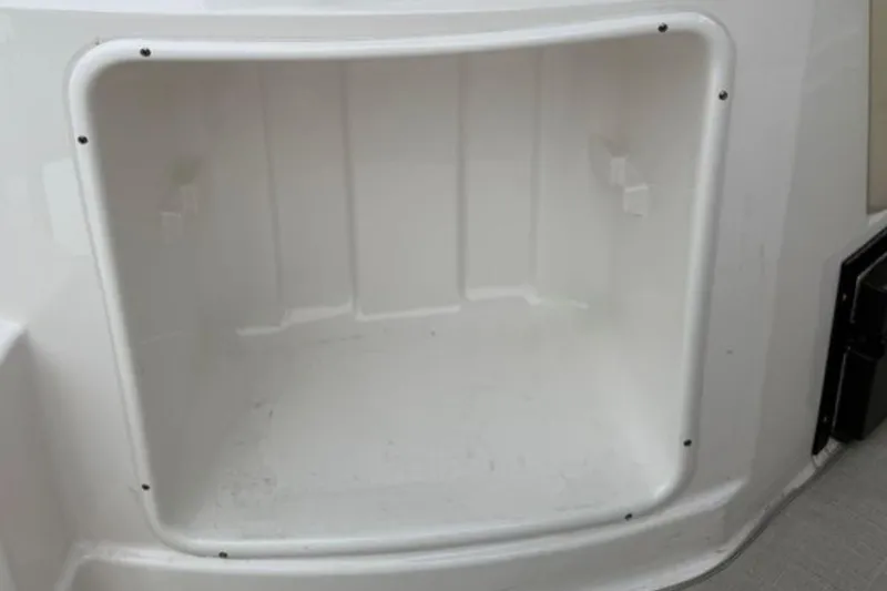 Slide: The Image of Storage compartment of a 2020 Regal 28 Express boat, featuring a clean, white interior. - 12