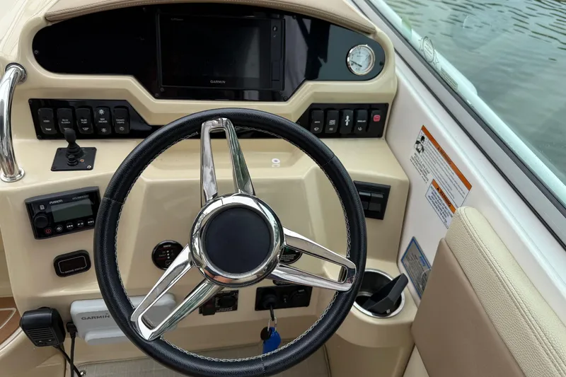 Slide: The Image of 2020 Regal 28 Express boat dashboard with steering wheel and control panel. - 18