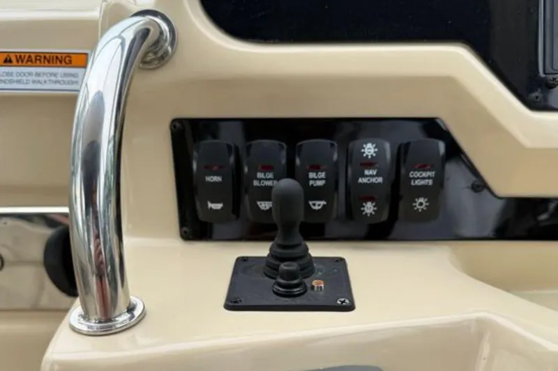 Slide: The Image of Control panel of a 2020 Regal 28 Express boat with switches and joystick. - 19