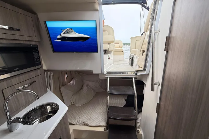 Slide: The Image of Interior of 2020 Regal 28 Express boat with kitchenette and sleeping area. - 22