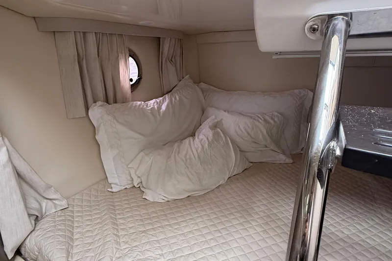 Slide: The Image of Cozy cabin interior of 2020 Regal 28 Express boat with plush bedding. - 23