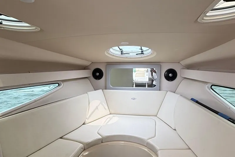 Slide: The Image of Interior of 2020 Regal 28 Express boat with beige seating and circular skylight. - 25