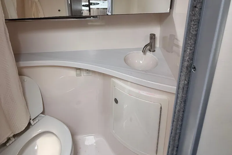 Slide: The Image of 2020 Regal 28 Express boat bathroom with compact sink and toilet. - 28