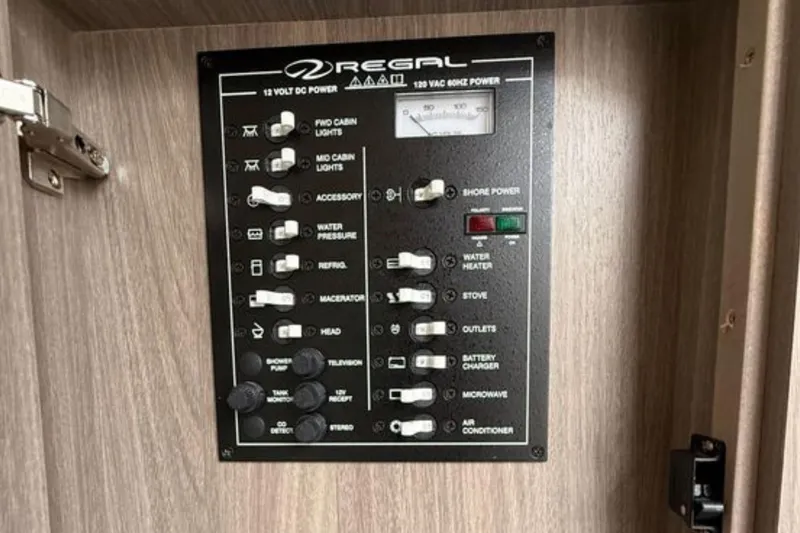 Slide: The Image of Control panel of a 2020 Regal 28 Express boat, featuring various switches and indicators. - 29