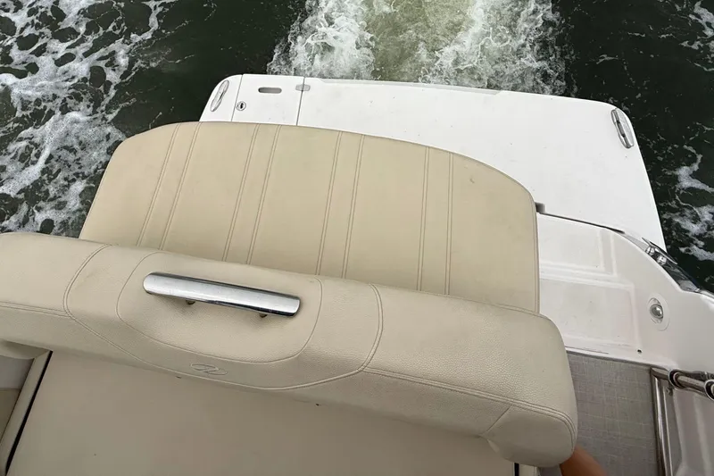 Slide: The Image of 2020 Regal 28 Express boat with beige seating and water view. - 8