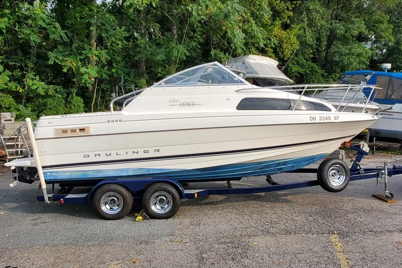 Slide: The Image of 1996 Bayliner 2252 Ciera Express boat on trailer, parked outdoors. - 10